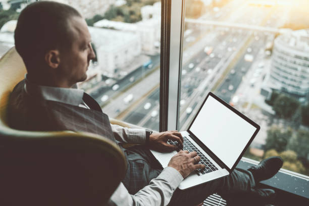 istock A businessman with a laptop mock-up 1254893651
