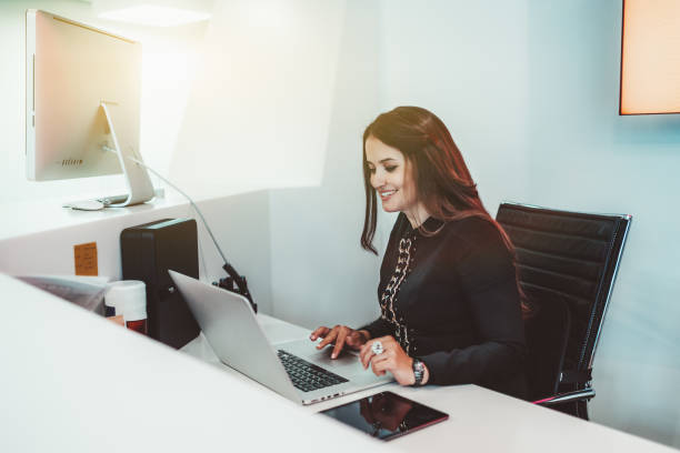 Woman receptionist with a laptop