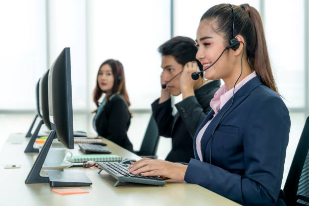 istock Business people wearing headset working in office 1254893870