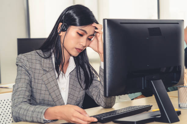 istock Business people wearing headset feel unhappy working in office 1254894503