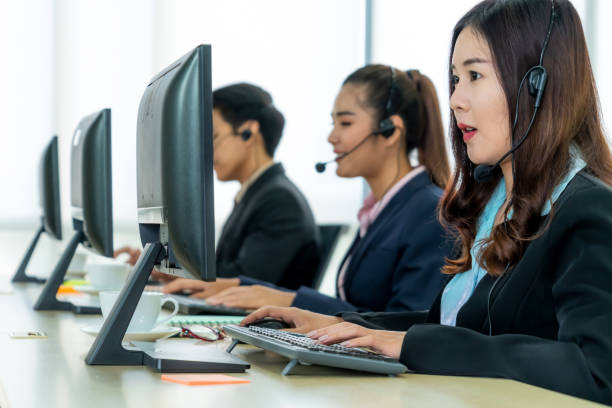 istock Business people wearing headset working in office 1254896981