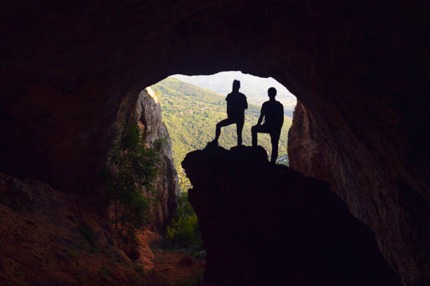 istock Young adventurers exploring the cave 1254897071
