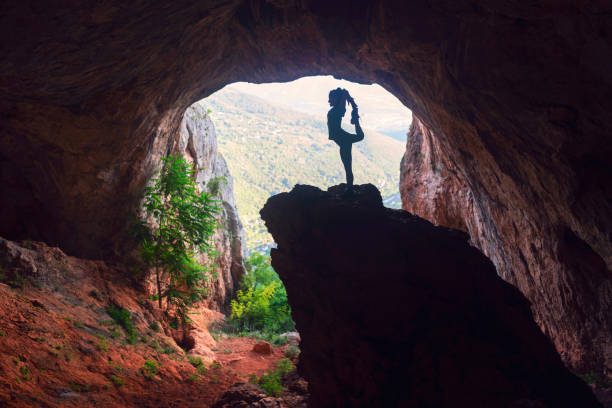 istock Woman doing yoga in cave 1254897078