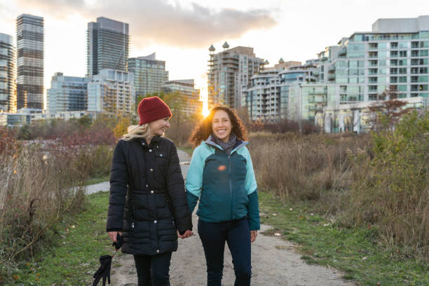 istock Women on winter walk through city park 1254897931