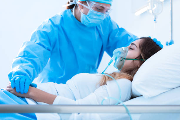 Nurse comforting a sick patient in the ward stock photo