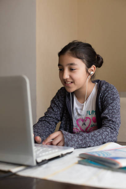 istock Happy girl enjoying e-learning, chatting with friends over internet, video conference 1254898296