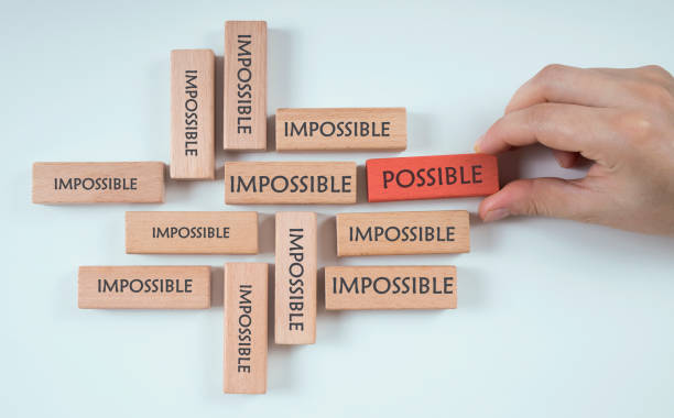 istock hand chooses possible cube among the cubes that says impossible 1254899412