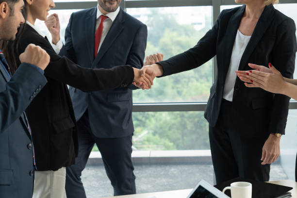 istock Business people handshake in corporate office 1254905675