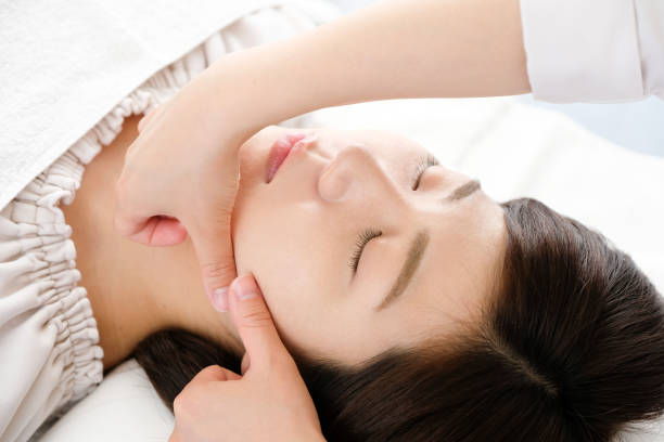 istock Hands of women and practitioners receiving face massage 1254908521