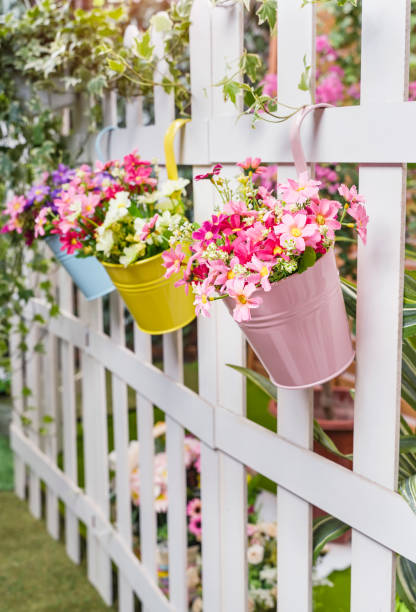 istock Hanging Flower Pots with fence 1254908532