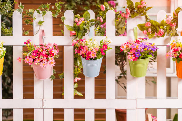 istock Hanging Flower Pots with fence 1254909972