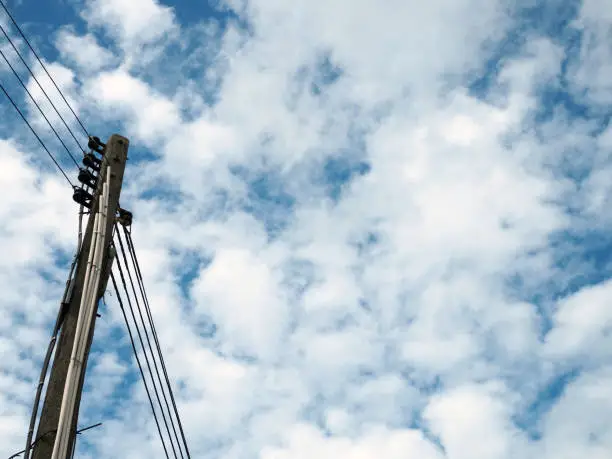 Electric pole and electric wire On the background is an empty blue sky."nMinimal concept.