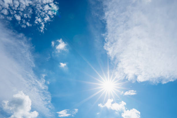 istock sun on blue sky with sunbeams and clouds in the day 1254913129