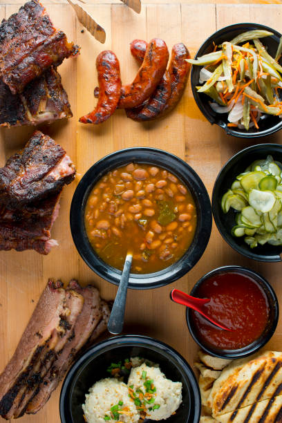 istock Barbecue. Picnic BBQ table spread. Beef brisket, chicken, pork ribs, beef ribs, Mac n cheese, cornbread, Brussels sprouts, coleslaw, and beer. Classic traditional Texas bbq meats and side dishes. 1254913152