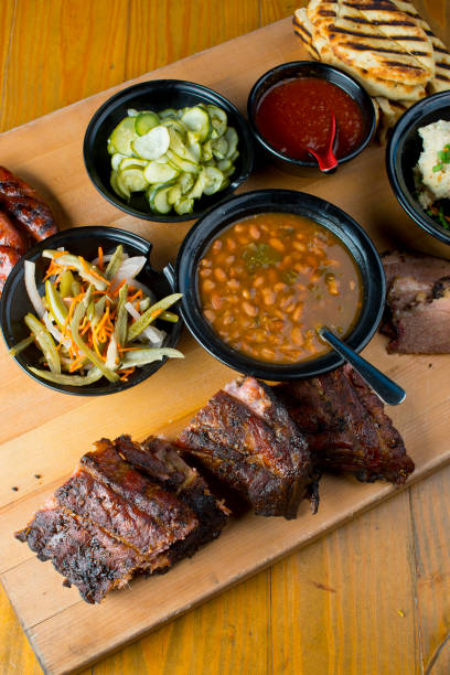 istock Barbecue. Picnic BBQ table spread. Beef brisket, chicken, pork ribs, beef ribs, Mac n cheese, cornbread, Brussels sprouts, coleslaw, and beer. Classic traditional Texas bbq meats and side dishes. 1254913155