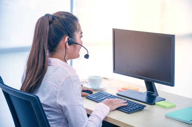 istock Young customer service women agent with headsets and computer working at office. 1254915717