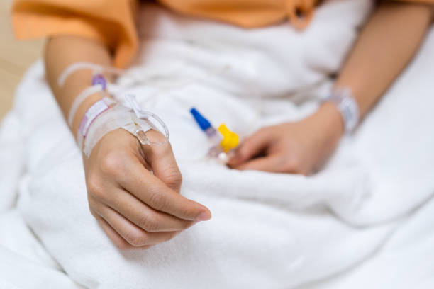 istock patient hand in hospital with a saline 1254919902