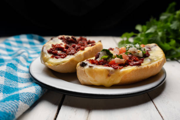 istock Mexican molletes with chorizo and fresh sauce on white background 1254920786