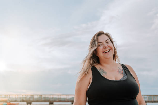 istock Latin woman smiling on the beach 1254922312