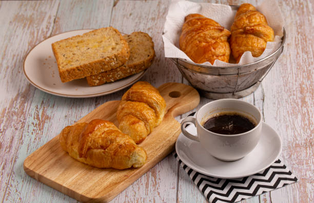 istock freshly baked croissants and whole wheat bread with black coffee 1254923952