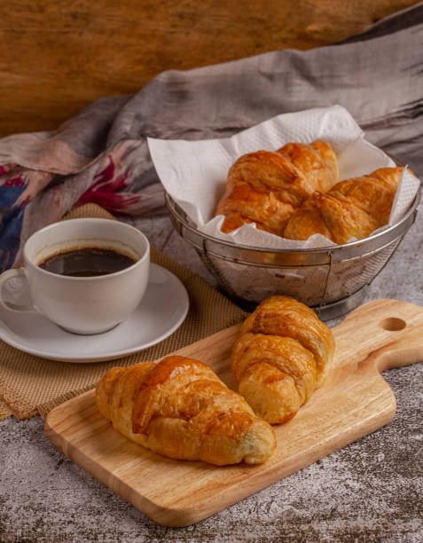 istock freshly baked croissants with black coffee on grey table for breakfast 1254923955