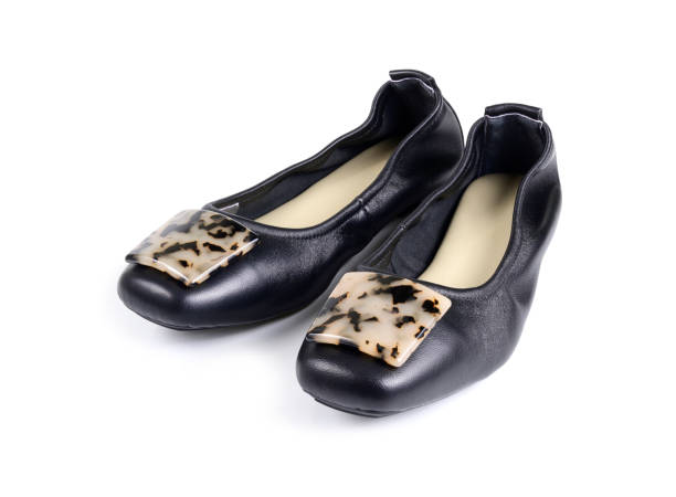 istock black ladies' flat shoes on white background. 1254924041