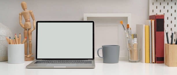istock Modern workspace with mock-up laptop, stationery, painting tools and decorations 1254924205