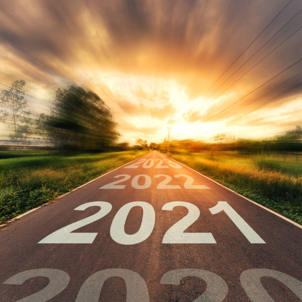 istock New Year Concept : Empty asphalt road sunset and New Year 2021. 1254929281