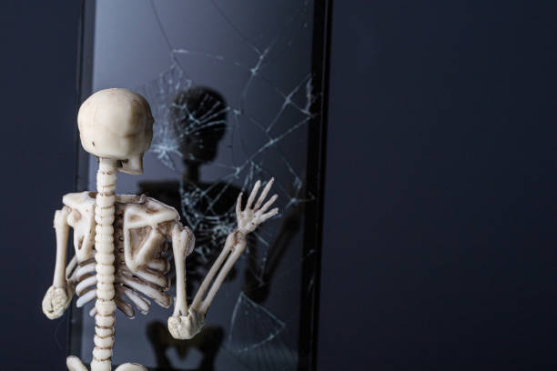 istock the human skeleton looks in a dark mirror with cracks 1254932334