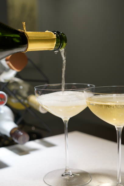 istock Champagne pouring into the glass 1254932383