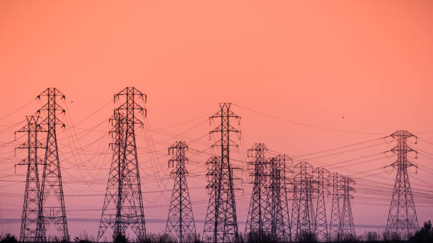 Sunset view of high voltage electricity towers on the shoreline of San Francisco bay area; California Sunset view of PG&E high voltage electricity towers on the shoreline of San Francisco bay area; California high voltage sign stock pictures, royalty-free photos & images