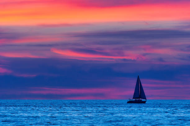 istock Sunset Sailboat Night Ocean Journey 1254938278