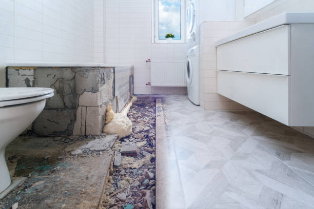 Bathroom renovation before and after. Laying new stone tiles in modern math room. Comparison view of floor reconstruction