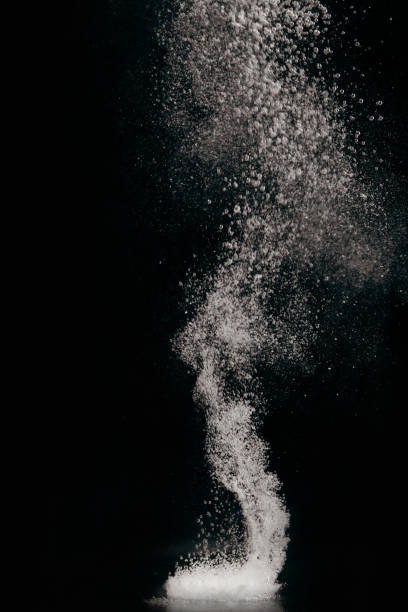 tableta disolviéndose en agua con burbujas sobre fondo negro - dissolving fotografías e imágenes de stock