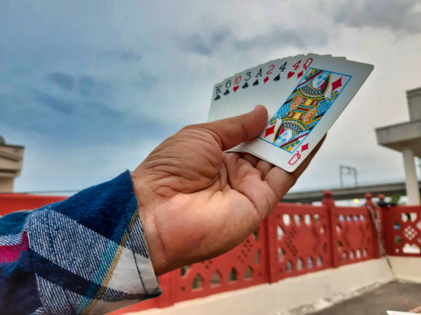 istock Person playing cards 1254942309
