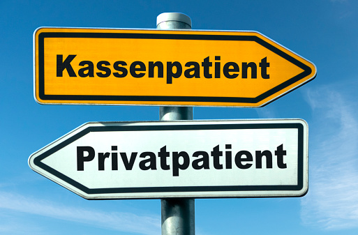 Selection of statutory or private health insurance in Germany symbolized by directional signs