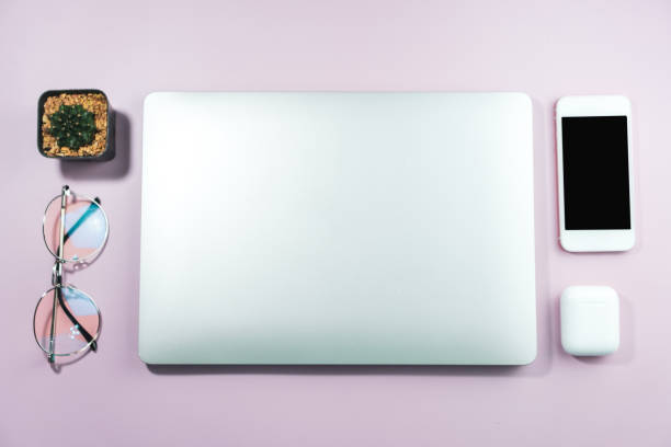 istock Top view of modern laptop or notebook with phone to work. Office desktop on table background. 1254944952