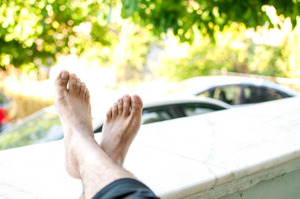 Man resting feet by the garden