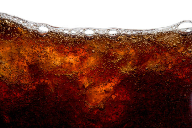 istock Cola soda bubble foam with ice in glass cold drink beverage background 1254947466
