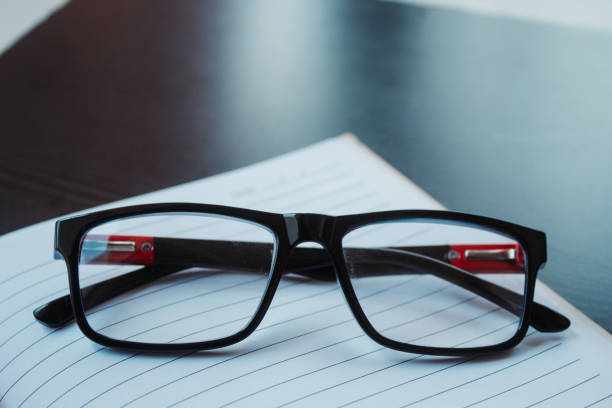 istock Glasses on top of the book 1254947651