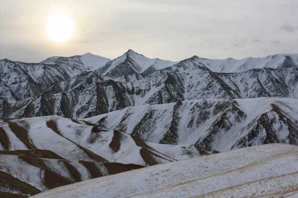 istock Cold evening sun over a mountain pass in winter. 1254947804