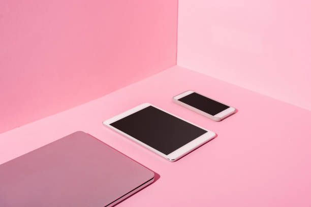 modern gadgets with blank screens on pink background