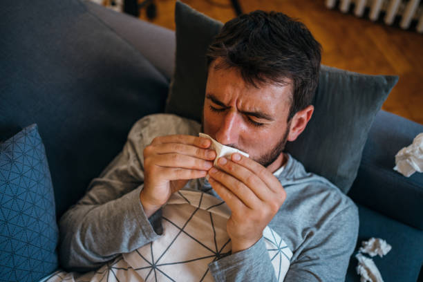 istock Sick man blowing the nose 1254948868