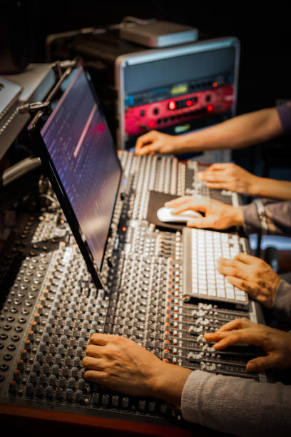 engineer team hands working on digital mixing console and studio equipment in recording, broadcasting studio. post production concept - human finger sound mixer music producer imagens e fotografias de stock