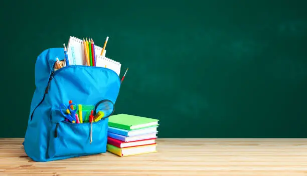 Photo of School bag. Backpack with supplies for school