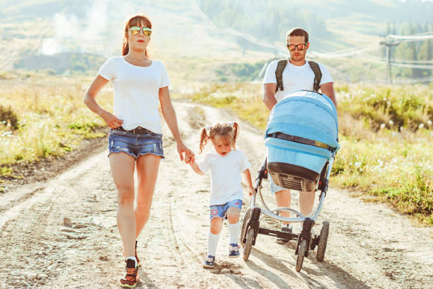 istock a young couple with a stroller on a walk 1254950562
