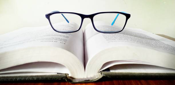 istock An open book and spectacles is on the book 1254950838