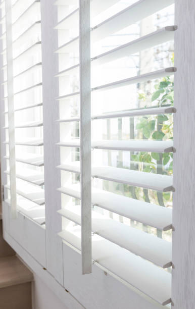 istock Faux wood white window blinds at home 1254951522