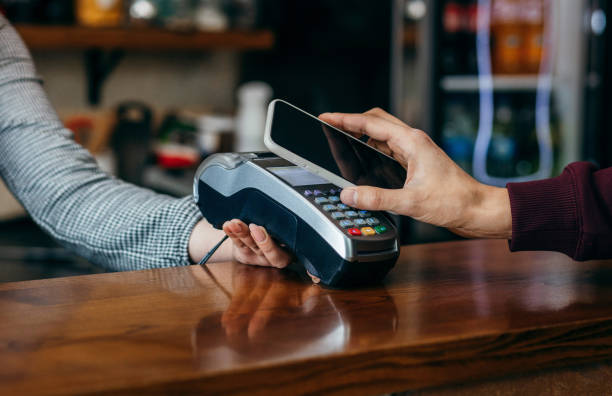 istock Payment transaction with smartphone in cafe 1254952714