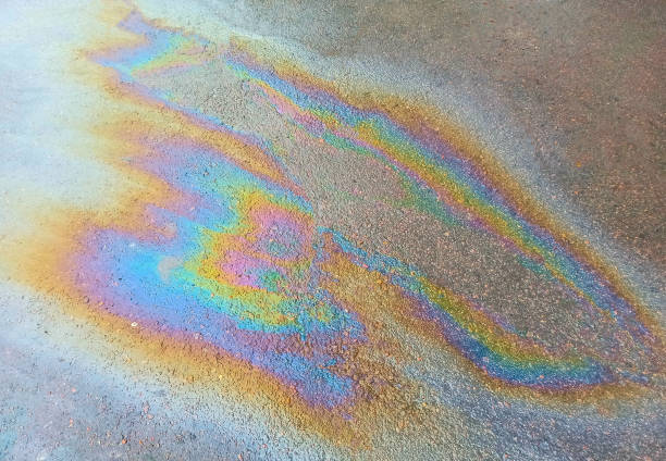 istock Petrol stain on the ground. Nature pollution. 1254953885